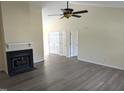 Open living room with high ceilings, fireplace, and wood-look flooring at 212 Davis Farm Dr, Selma, NC 27576