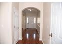 Bright foyer featuring hardwood floors, neutral walls, and classic white trim at 212 Liberty Rose Dr, Morrisville, NC 27560