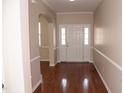 Bright foyer featuring hardwood floors, neutral walls, and classic white trim at 212 Liberty Rose Dr, Morrisville, NC 27560