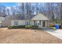 Charming single-story home features a cozy front porch and blue shutters at 220 Courtland Dr, Angier, NC 27501