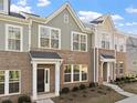 Attractive exterior of a townhome displaying brick facade, large windows, and a covered entryway at 223 Frosted Iris Lane Ln # 176, Garner, NC 27529
