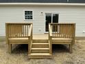 Close up of the back deck made of wood, featuring stairs and railings at 2242 Eldridge Rd, Newton Grove, NC 28366