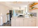 Well-lit kitchen with a mix of white and stainless steel appliances, granite counters, and hardwood flooring at 2513 Boothbay Ct, Raleigh, NC 27613
