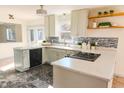 Modern kitchen featuring white cabinets, granite countertops, stainless steel appliances, and stylish tile backsplash at 2513 Boothbay Ct, Raleigh, NC 27613
