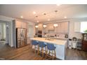 Spacious kitchen with a large island, modern appliances, and pendant lighting at 311 Silverhawk Ln, Durham, NC 27703