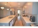 Contemporary kitchen with sleek cabinetry, a large island, and ample counter space at 311 Silverhawk Ln, Durham, NC 27703