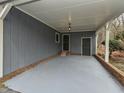 Spacious carport area with painted concrete flooring and access to side entry door at 314 Mill Creek Dr, Fuquay Varina, NC 27526