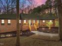 Inviting brick home featuring a charming entryway and freshly mulched garden beds at 3217 Stoneyford Ct, Raleigh, NC 27603