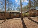 A brick home with mature trees and landscaping, highlighted by a covered entryway at 3217 Stoneyford Ct, Raleigh, NC 27603