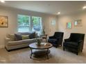 Bright living room features plush seating, neutral walls, large windows, and stylish decor for a welcoming atmosphere at 349 Tristen Ln, Henderson, NC 27537