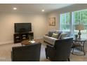 Comfortable living room with plush seating and natural light from large windows overlooking the surrounding nature at 349 Tristen Ln, Henderson, NC 27537
