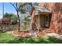 Charming side yard with brick accents, a picket fence, and flowering trees at 3529 Elk St, Burlington, NC 27215