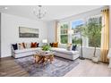Sunlit living room featuring stylish decor, comfortable seating, and large windows offering pleasant outdoor views at 359 Church St # 60, Wendell, NC 27591