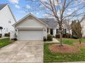 Lovely single Gathering home featuring an attached garage and well maintained landscaping at 409 Latta Cir, Durham, NC 27712