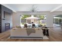 Open concept living room with pool view through sliding glass doors and modern fireplace at 4300 Camelot Dr, Raleigh, NC 27609