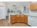 Well-lit kitchen with wooden cabinets, white countertops, and modern appliances at 4308 Brynwood Ave, Durham, NC 27713