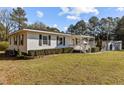 An angled view of the home, showcasing its well-manicured lawn, attractive siding, and inviting front porch at 4316 Old Faison Rd, Knightdale, NC 27545