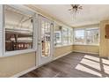 Bright sunroom featuring hardwood floors, multiple windows offering natural light, and access to outdoor spaces at 4316 Old Faison Rd, Knightdale, NC 27545