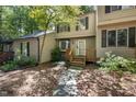 Charming exterior of townhome showcasing the entrance with a stone pathway and lush landscaping at 502 Forest Court, Carrboro, NC 27510