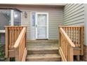 A view of the front door with wood steps and railings leading up to the front porch at 502 Forest Court, Carrboro, NC 27510