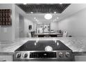 Kitchen with granite counters and stainless steel range, opening to the living/dining areas at 543 Pine Ridge Place, Raleigh, NC 27609