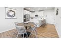 Open-concept kitchen and dining area with stainless appliances and a breakfast bar at 600 Hedrick Ridge Road # 104, Cary, NC 27519