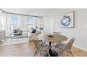 Bright living area with large windows, wood floors, and a comfortable seating arrangement at 600 Hedrick Ridge Road # 104, Cary, NC 27519