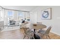 Charming dining area with a round table, comfortable seating, and bright natural light from large windows at 600 Hedrick Ridge Road # 108, Cary, NC 27519