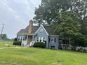 Inviting blue home with well-maintained lawn and mature trees at 601 Aiken Pkwy, Fuquay Varina, NC 27526