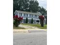 Two-story blue home with dark shutters and vibrant red crape myrtle trees at 601 Aiken Pkwy, Fuquay Varina, NC 27526