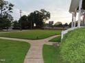 Spacious front yard with a winding pathway and lush landscaping at 601 Aiken Pkwy, Fuquay Varina, NC 27526