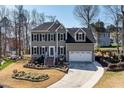 Attractive two-story house with a well-maintained lawn, two-car garage, and inviting entryway at 604 Chadbourne Dr, Durham, NC 27703