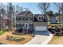 Inviting two-story home with an attached garage, landscaped yard, and a welcoming front entrance with stairs at 604 Chadbourne Dr, Durham, NC 27703