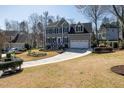 Traditional two-story home featuring a two-car garage, manicured lawn, and a paved driveway on a sunny day at 604 Chadbourne Dr, Durham, NC 27703