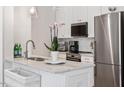 Well-lit kitchen with marble countertops, stainless steel appliances, and modern fixtures at 605 Smedes Pl # B, Raleigh, NC 27605