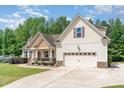 Beautiful home with a well-manicured lawn and a spacious driveway leading to a two-car garage at 70 Breadnut Dr, Smithfield, NC 27577
