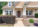 Inviting front porch with stone accents, offering a warm welcome to this charming home at 70 Breadnut Dr, Smithfield, NC 27577