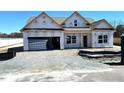 New construction home featuring an attached garage, gabled roof and classic window styles at 86 Olivia Crossing Ct # 3, Four Oaks, NC 27524