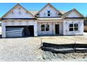 New construction home featuring an attached garage, gabled roof and classic window styles at 86 Olivia Crossing Ct # 3, Four Oaks, NC 27524