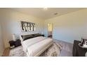 Bright bedroom featuring neutral decor, plush carpet, and ample closet space at 1128 Solace Way, Rolesville, NC 27571