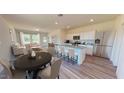 Open-concept living area connecting a modern kitchen, dining area, and cozy sitting area at 1128 Solace Way, Rolesville, NC 27571