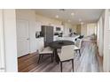 Cozy dining area with contemporary table and chairs, adjacent to the well-equipped kitchen at 1156 Solace Way, Rolesville, NC 27571