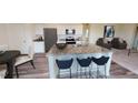 Stylish kitchen island with granite countertops, bar seating, and modern appliances at 1156 Solace Way, Rolesville, NC 27571