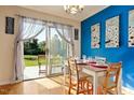 Bright dining area with sliding glass doors to the backyard and seating for four at 124 Friar Ln, Carrboro, NC 27510