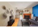 Open living space with hardwood floors, a fireplace, and a view of the dining area at 124 Friar Ln, Carrboro, NC 27510