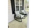 Inviting front porch with rocking chairs, ideal for relaxing outdoors at 128 Madeline Ct, Youngsville, NC 27596
