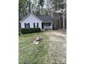 Quaint one-story house featuring a cozy front porch and lush green shrubbery at 128 Madeline Ct, Youngsville, NC 27596