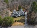 Aerial view of the property showing the house, driveway, and surrounding trees at 180 Normandy Rd, Louisburg, NC 27549