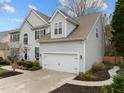 Charming two-story home features a two-car garage, well-maintained lawn and beautiful landscaping at 209 Plyersmill Rd, Cary, NC 27519
