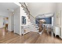 Bright foyer with hardwood floors, staircase, and views to the dining room at 209 Plyersmill Rd, Cary, NC 27519